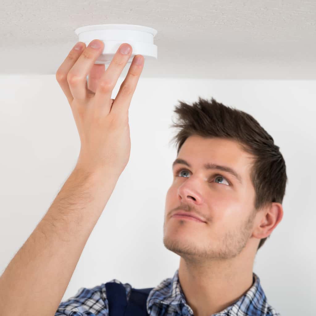 CLICK-A-PRO Service Tech Changing Batteries In A Smoke Detector