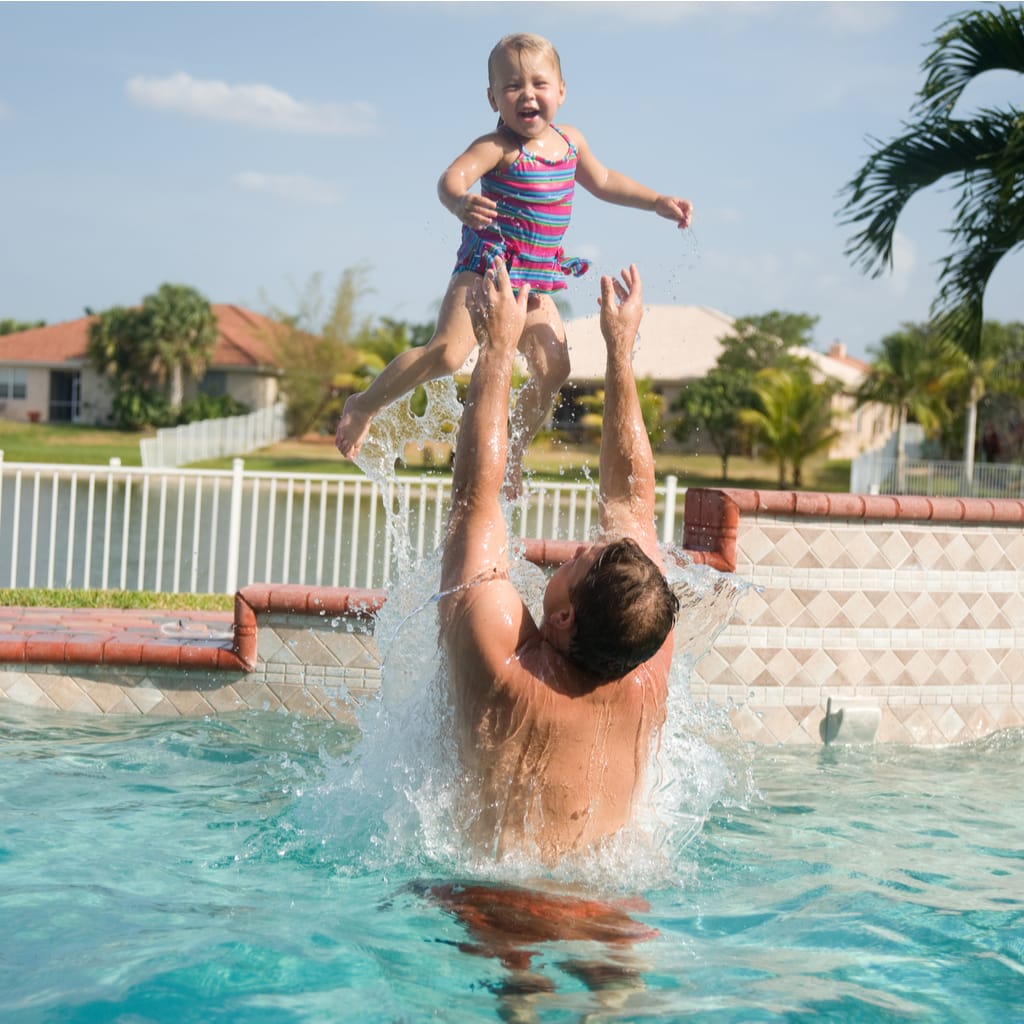 At Home In Scottsdale Arizona - Daddy and Daughter Enjoying Pool Time in The Backyard Overlooking A Private Lake