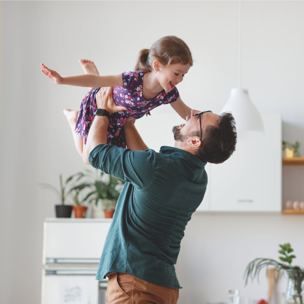 A Man Holding Up His Daughter So That She Can Play Airplane. He Ordered Home Services On www.clickapro.com So He Can Get Back To What Matters