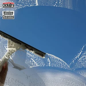 A squeegee cleaning a window. The camera is looking through the window toward the sky so that as the squeegee is passing by, a clear view of the sky is seen. Order window cleaning by Clickapro