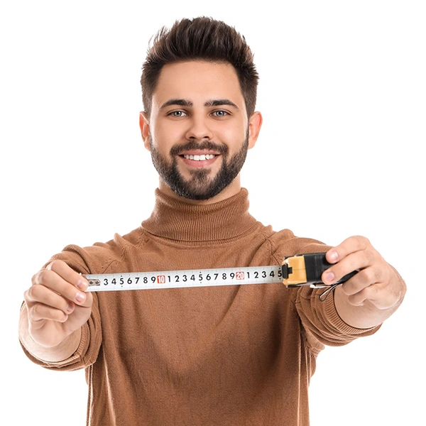 A Person Holding Up an inches Measuring Tape To Measure A Room To Calculate Square Feet