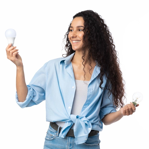 A woman is holding an LED light bulb and an incandescent light bulb. She isn't sure how to convert from incandescent watts to LED watts so she is using the Clickapro bulb calculator. Clickapro's Home Improvement Calculators are free for homeowners