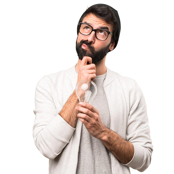 A man is holding a light bulb and wondering what wattage he needs. To find the answer, he will look at Clickapro's home improvement calculator for converting incandescent to LED bulb wattage.